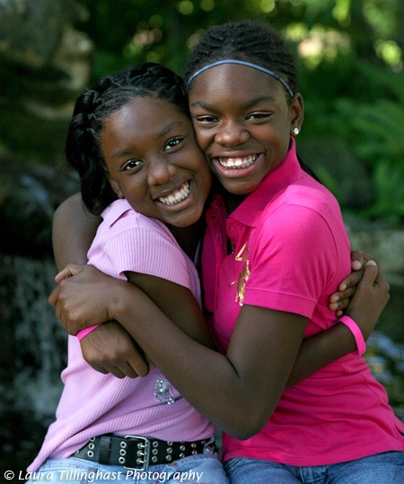 Kids wearing pink hugging