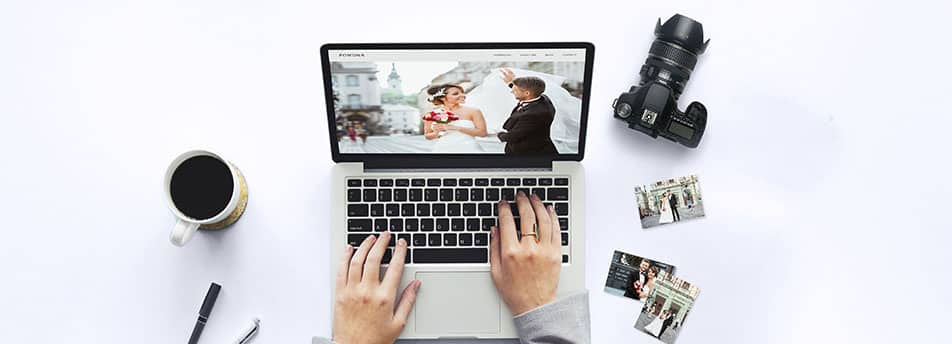 photographer with computer and camera and coffee