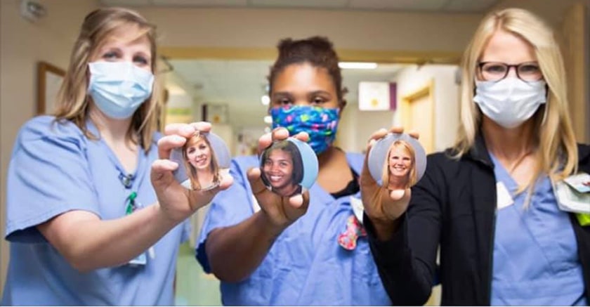 nurses wearing masks holding photo buttons
