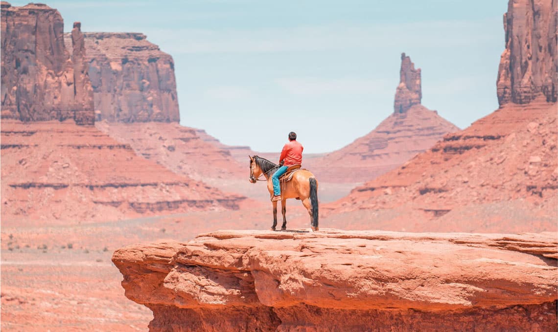 riding horseback in desert