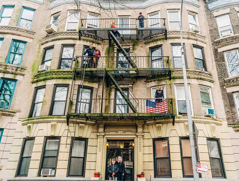 Family posed on fire escape balconies, New York City