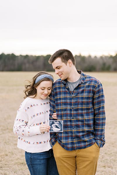 couple holding ultrasound photograph
