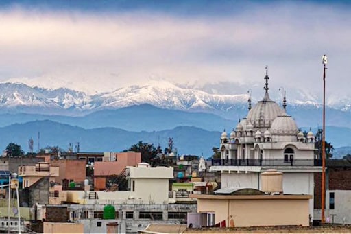 the Himalayas behind a cityscape in India