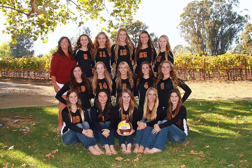 high school girls volleyball team with coach