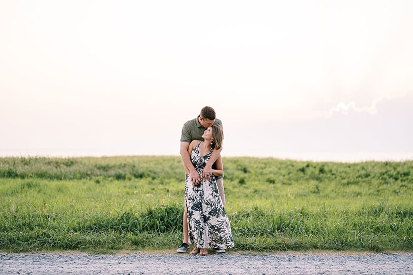 couple embracing in field