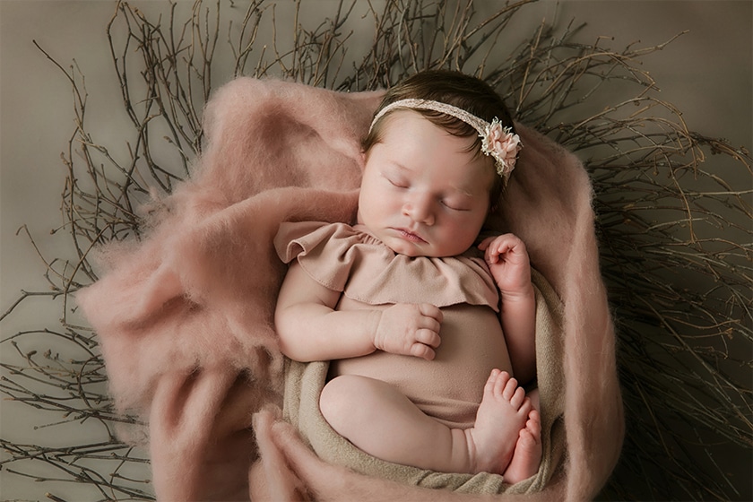 sleeping newborn on soft pink blanket