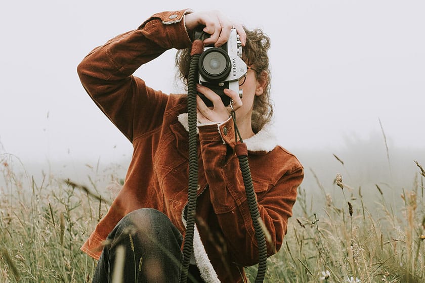 woman holding camera in foggy field