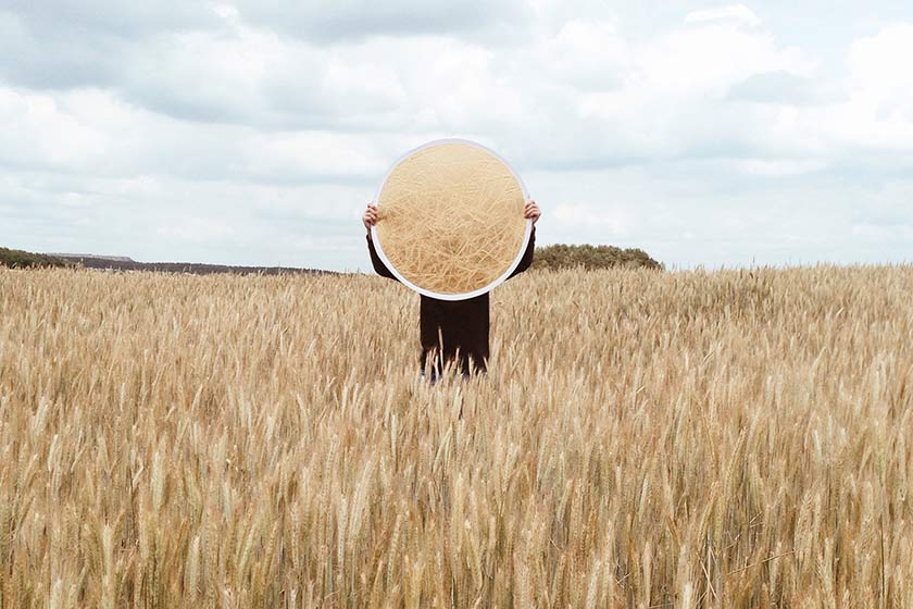person holding reflector in field