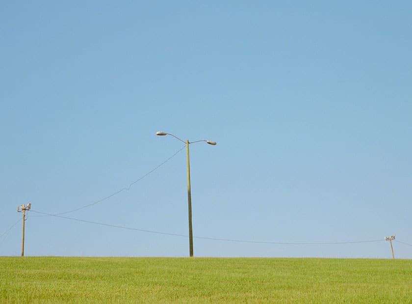 Open space with city light pole and power lines