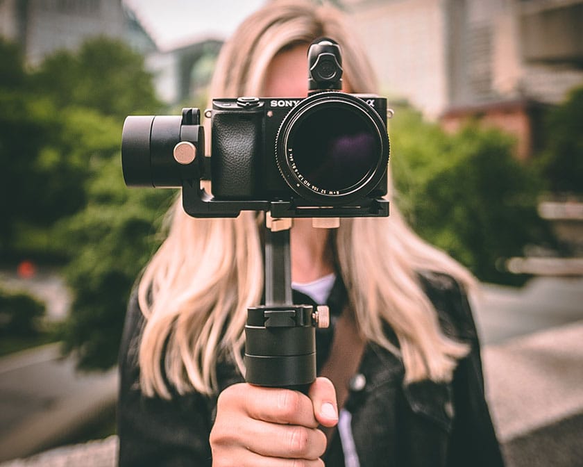 photographer holding camera mounted on gimbal