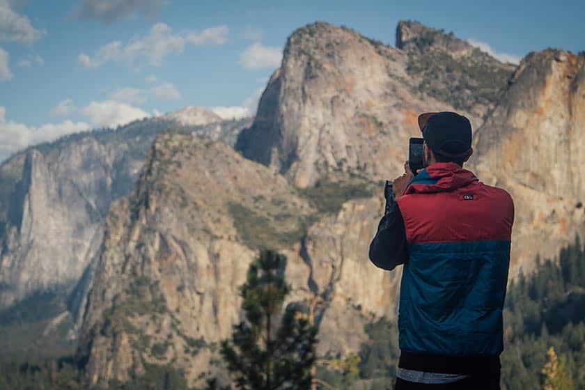 man photographing mountains