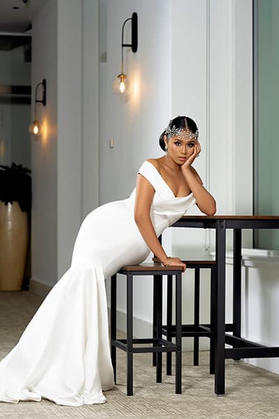 glamorous black bride posing on a bench