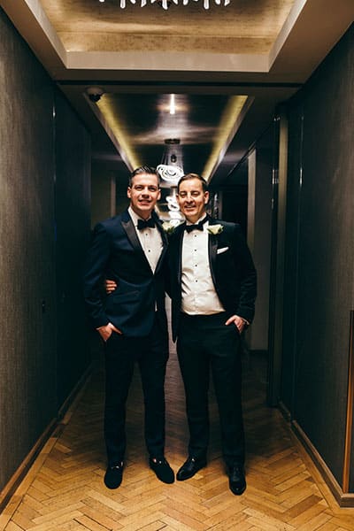 Portrait of two grooms in tuxes during their wedding