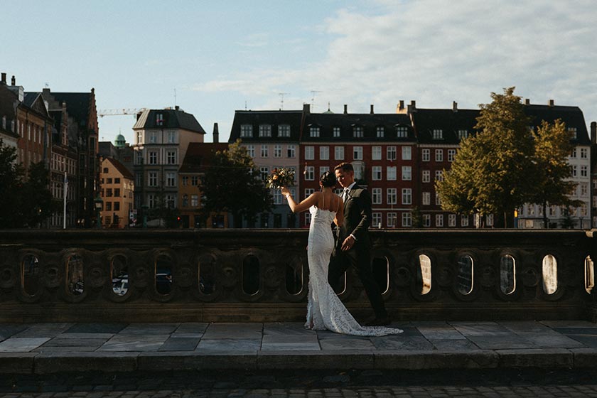 wedding couple walking together on a stone patio in a quaint city