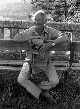 Portrait of Henri Cartier-Bresson sitting on a bench
