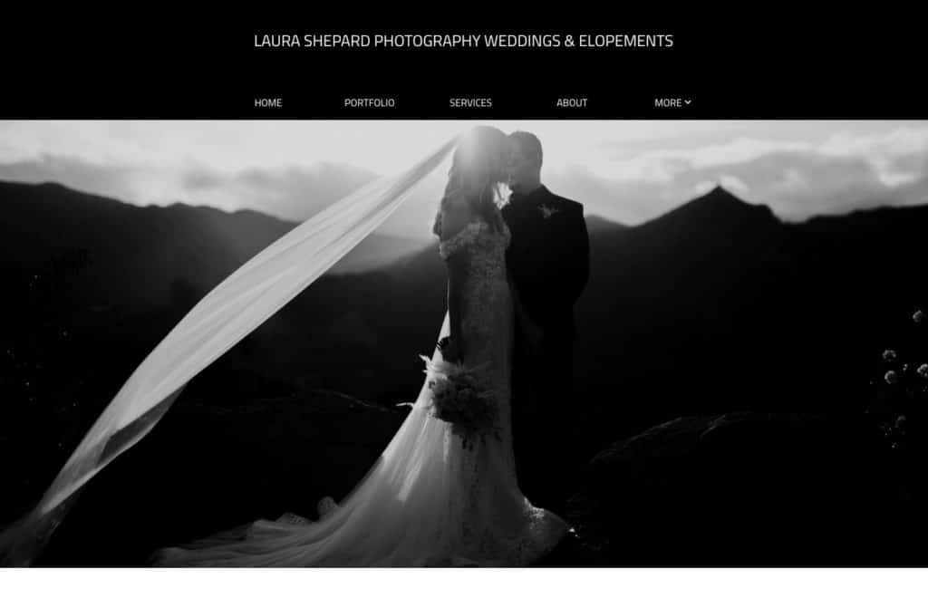 black and white image of a bride and groom standing close together on a mountaintop in dramatic light on the Laura Shepard Photography portfolio website