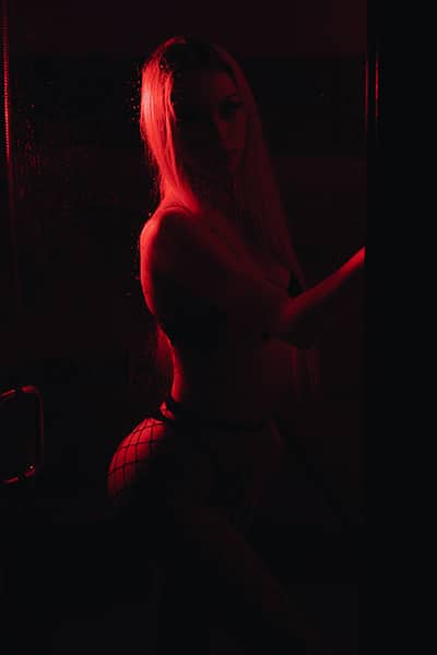 boudoir photo of women in low light with a red glow