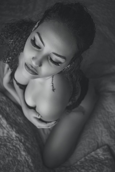 black and white boudoir photo of a woman shot from above