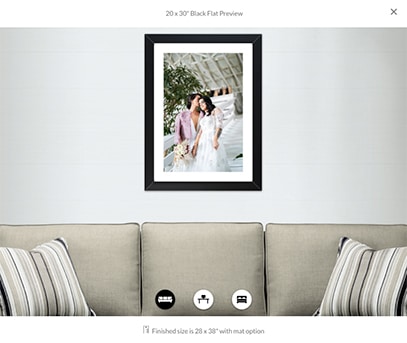 image preview showing a 20x30 inch framed print of two brides hanging above a beige couch
