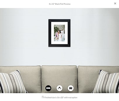 image preview showing an 8x12 inch framed print of two brides hanging above a beige couch