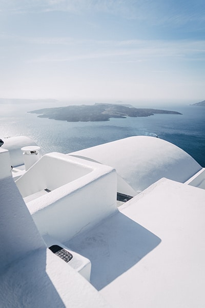 bright white building, sea, and distant island