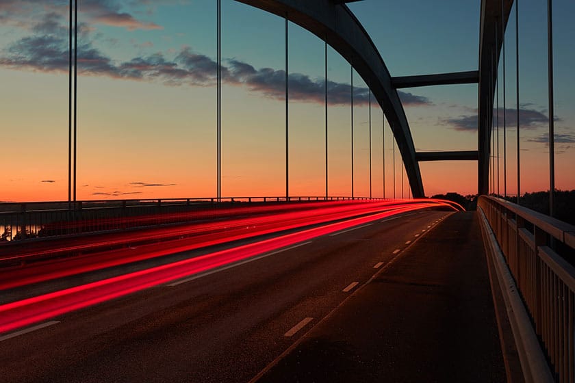 long exposure night landscape of bridge and red-tail light lines