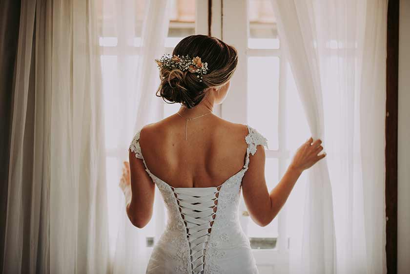 wedding portrait of the back of a bride wearing a corset-laced dress 