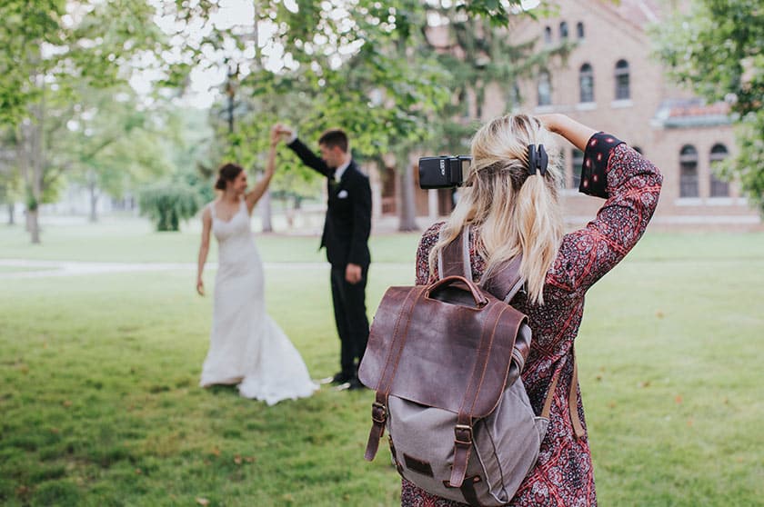wedding photographer taking an image of bride and groom