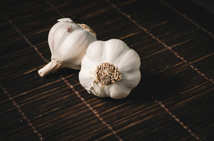 cloves of garlic on dark background