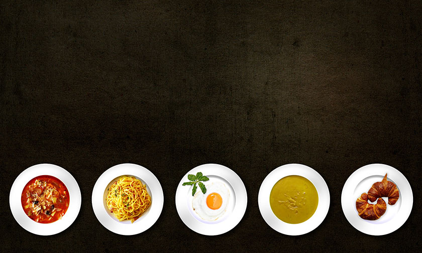 plates of food on black background