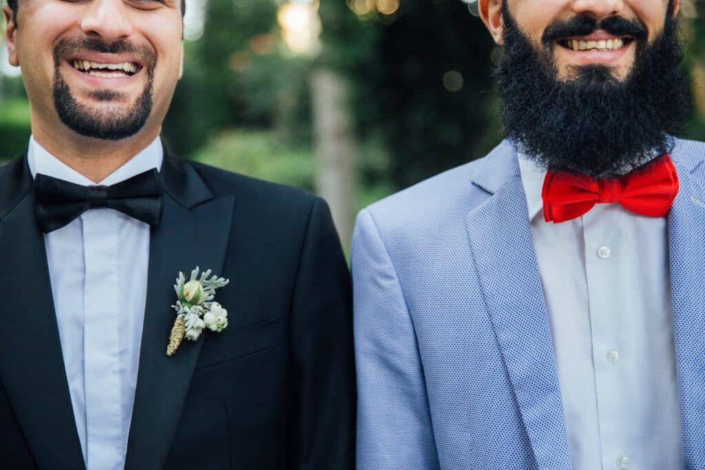 wedding detail two smiling grooms with bowties