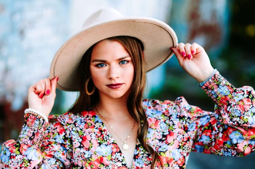 senior girl in floral top and hat