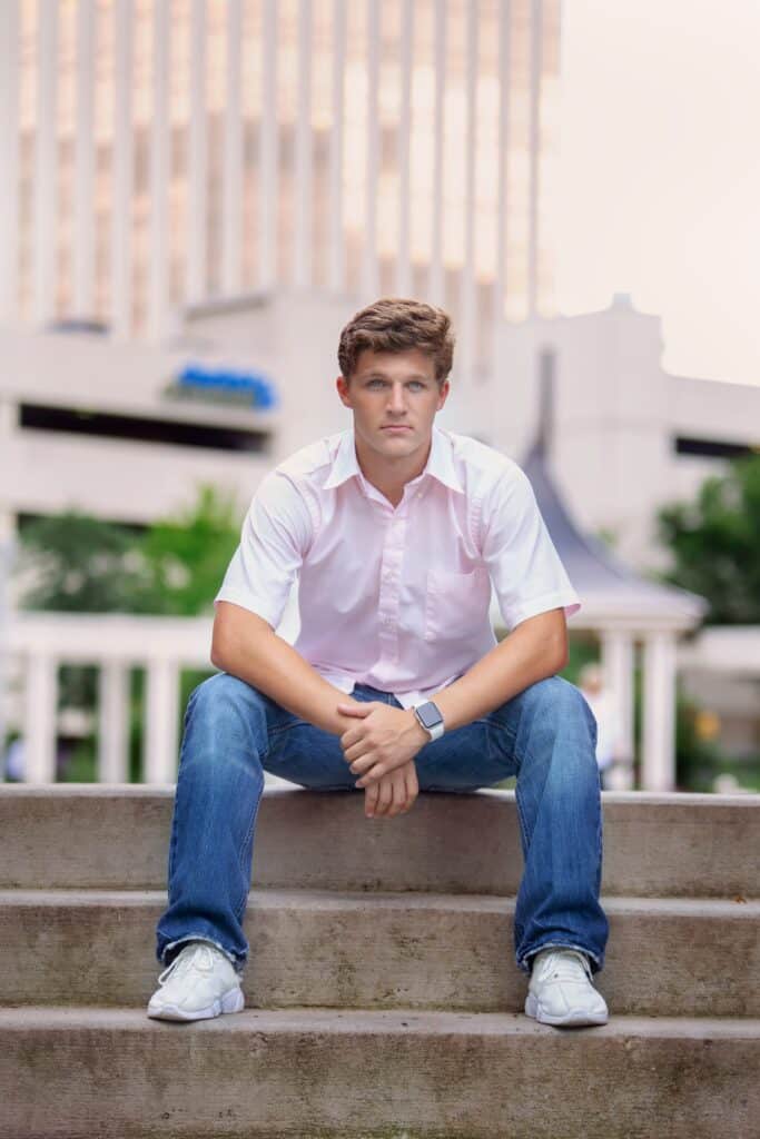senior boy sitting on concrete steps