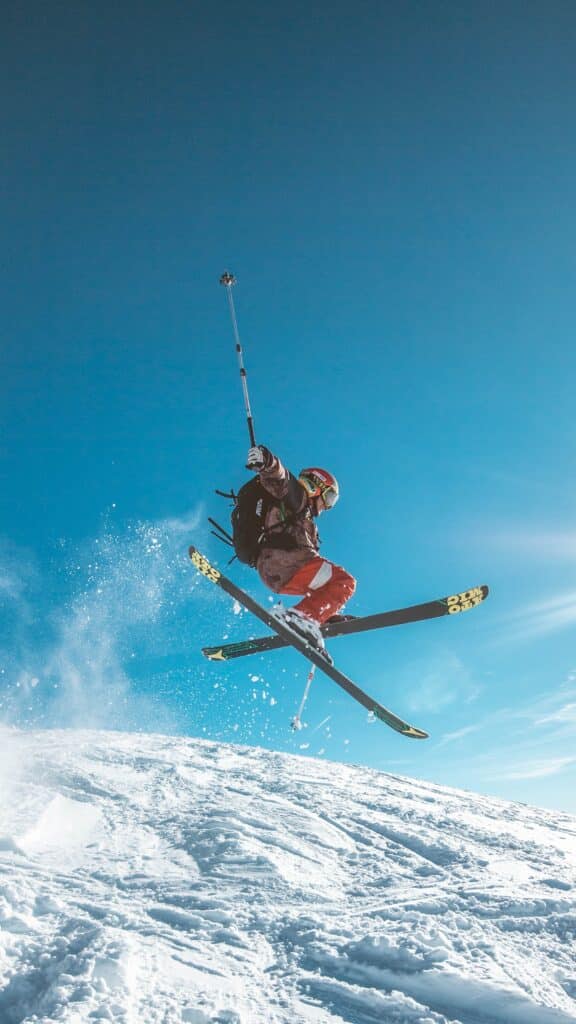 person skiing downhill on steep snowy slope
