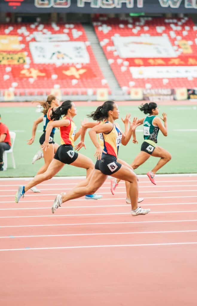 women running on track in stadium