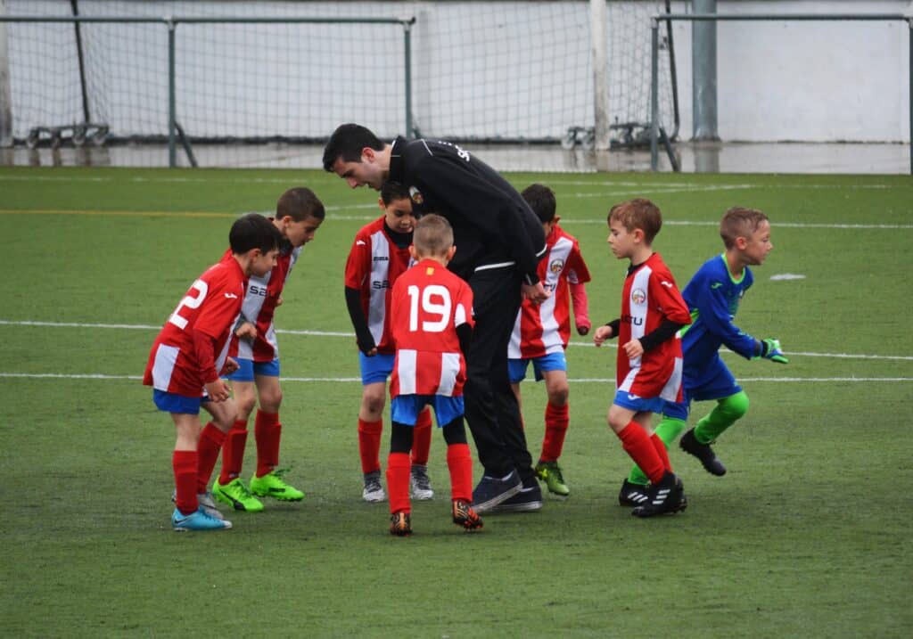 youth soccer coach with players