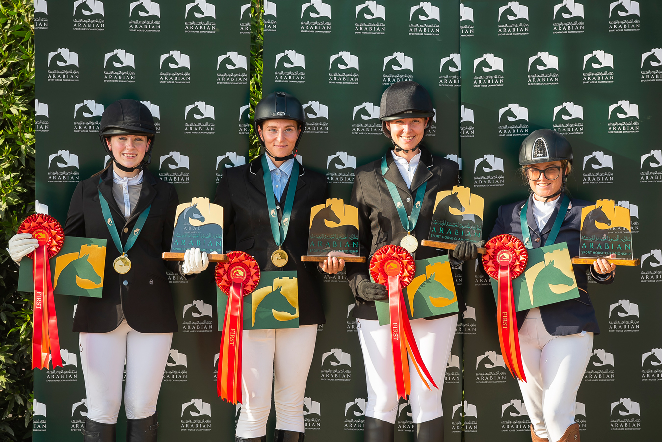 4 girls posing with ribbon awards for equestrian team portrait by Elizabeth Glanville