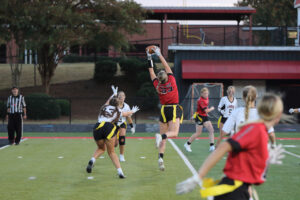 girl jumping to catch football during a touch football game 3880 Jonathan Leitner