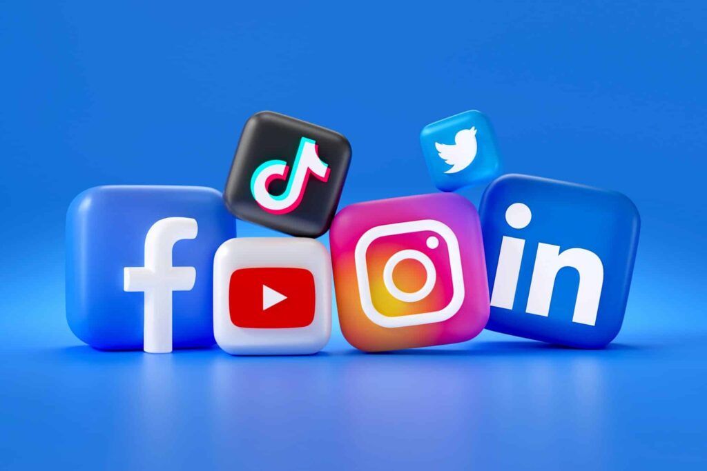 Social Media Logos in 3D cube shapes with a blue background. Includes Facebook, Instagram, Twitter, TikTok, YouTube, LinkedIn.