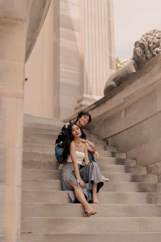 asian couple sitting together on stone steps 04921 Sam Reed