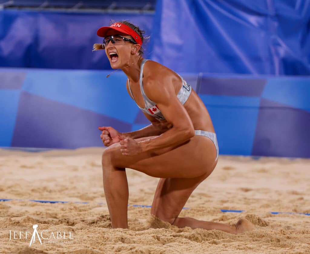 Woman kneeling in sand in excitement during Beach Volleyball competition at Tokyo 2020 Olympic Games, image by Jeff Cable Photography