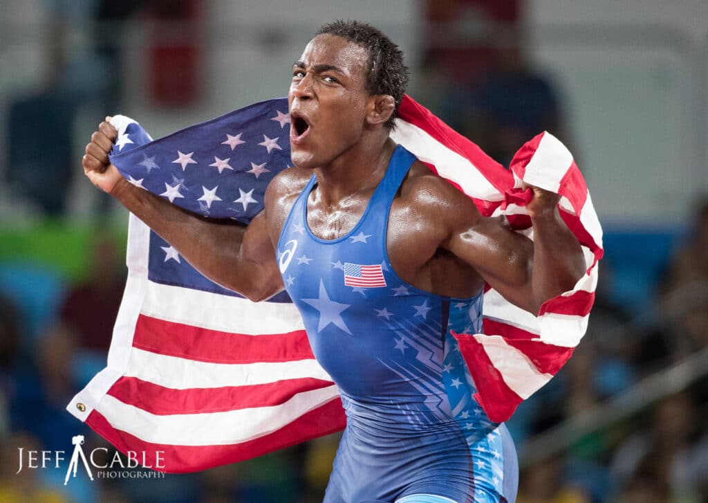 Wrestling athlete holding American flag, image by Jeff Cable Photography