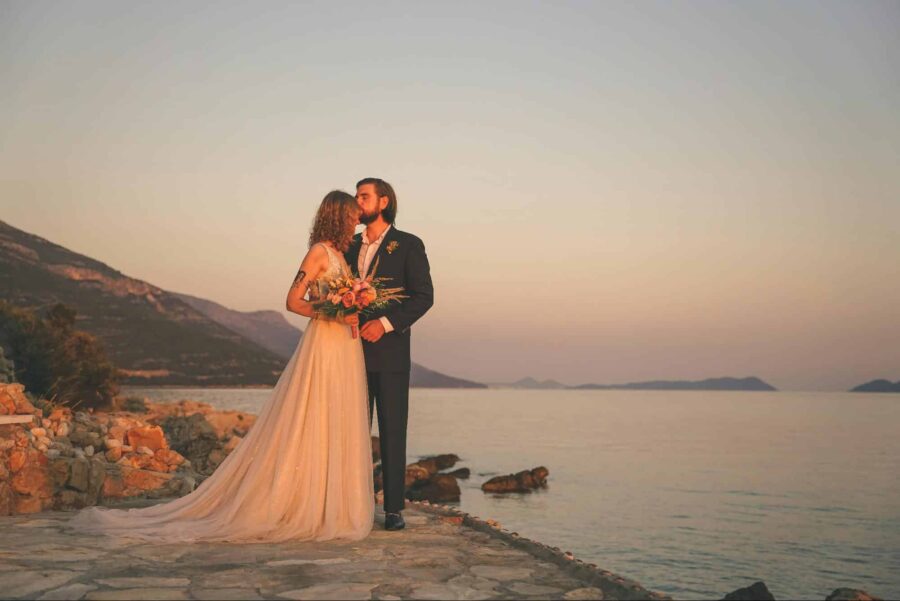 wedding couple posing together at sunset