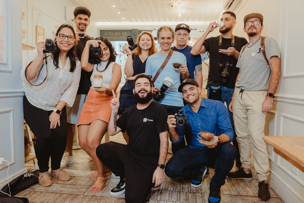 group picture of photographers holding their cameras and smiling