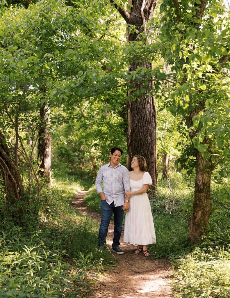 portrait of a man and woman side by side on a walking path in the woods by Heather Nelson.