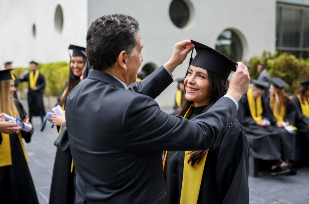father adjusting daughter's graduation cap