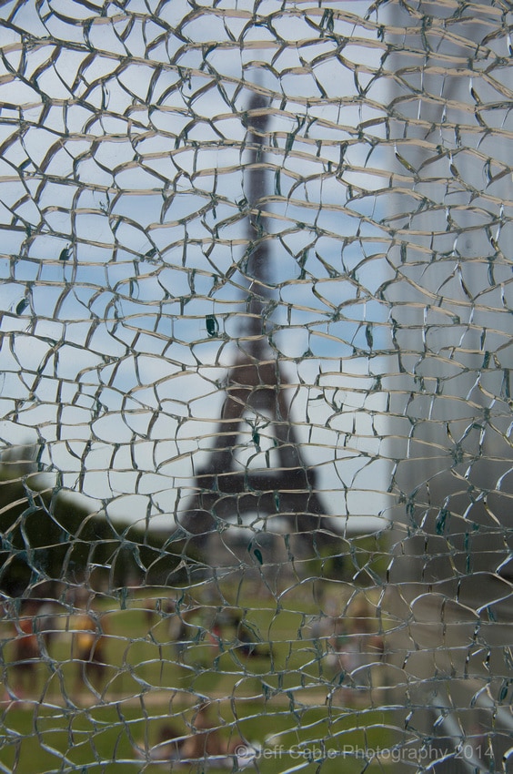 photo of Eiffel Tower through cracked glass